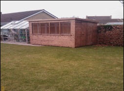 A long timber building with a run of windows