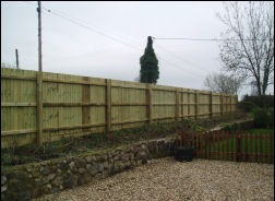 Close-board fencing with gravel boards