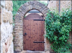 A timber side gate between walls