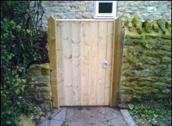 A timber gate in a stone arch