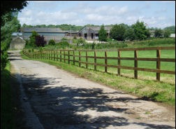 Post and rail fencing along a farm track