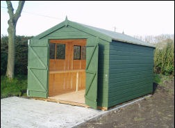 A green-painted apex shed