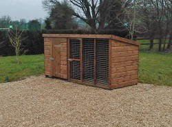 A small timber hut with a mesh run